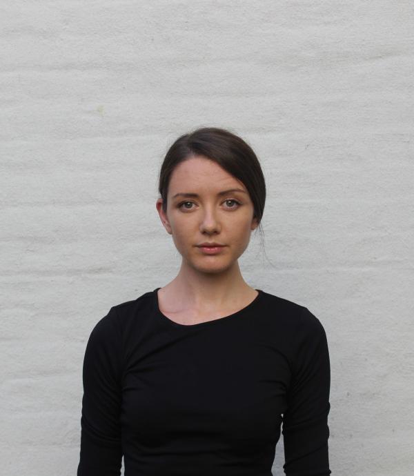 a person in a black shirt looking at the camera