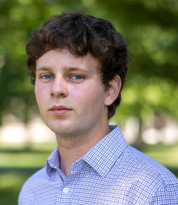 Person wearing checkered blue collared shirt